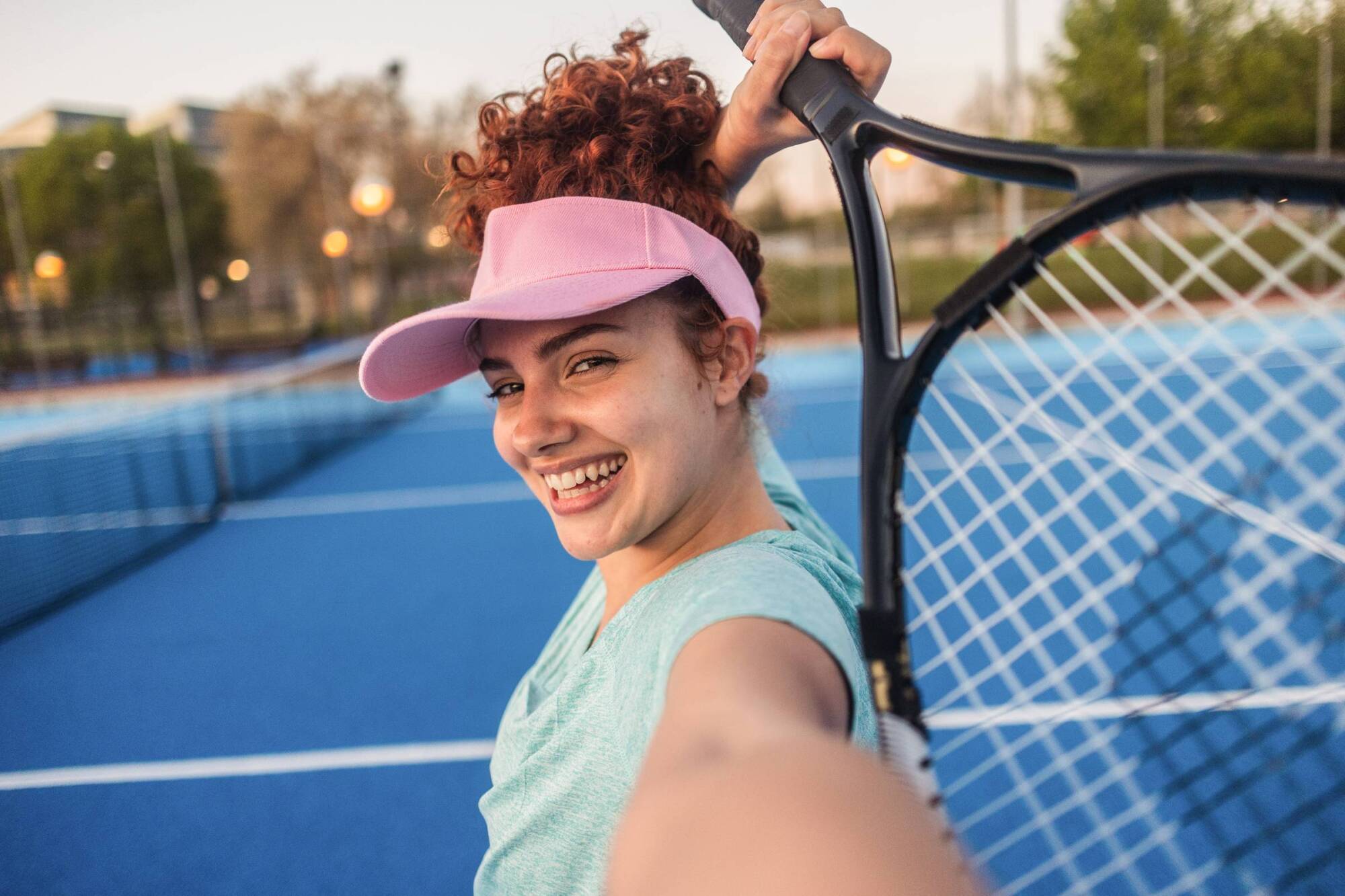 Woman playing tennis, smiling