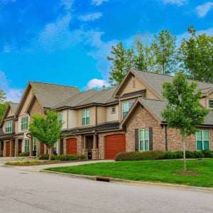 Townhomes at Chapel Watch Village community exterior with beautiful trees and grass, and spacious, quiet roads