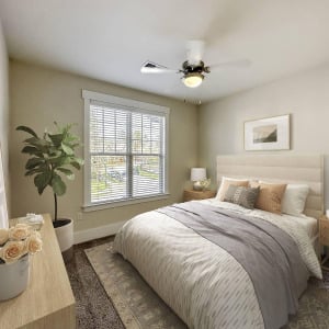 Townhomes at Chapel Watch Village townhome bedroom with a large bed, dresser, rug, ceiling fan, house plant, and window