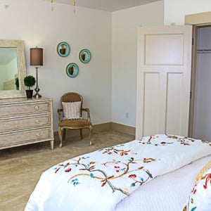 Townhomes at Chapel Watch Village townhome bedroom with a bed, dresser and mirror, and large closet