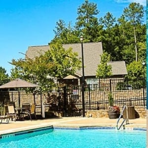 Townhomes at Chapel Watch Village community amenities Townhomes at Chapel Watch Village community amenities with a saltwater pool, clubhouse, and surrounding grass and trees