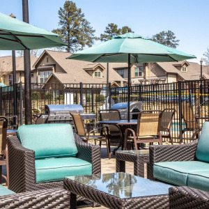 Townhomes at Chapel Watch Village community amenities with an outdoor patio furniture set lounge area by the pool