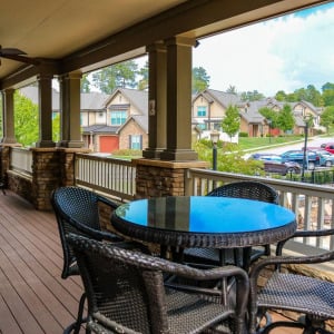 Townhomes at Chapel Watch Village community amenities with a clubhouse deck, table, and chairs