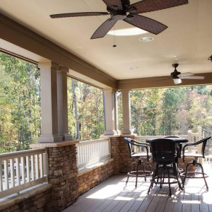 Townhomes at Chapel Watch Village community amenities with the clubhouse deck, ceiling fan, table and chairs