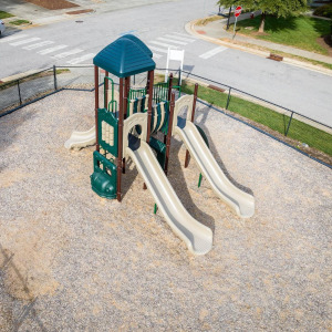 Townhomes at Chapel Watch Village community amenities with a fenced playground