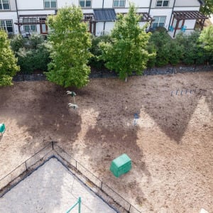 Townhomes at Chapel Watch Village community amenities with an aerial of a large on-site dog park