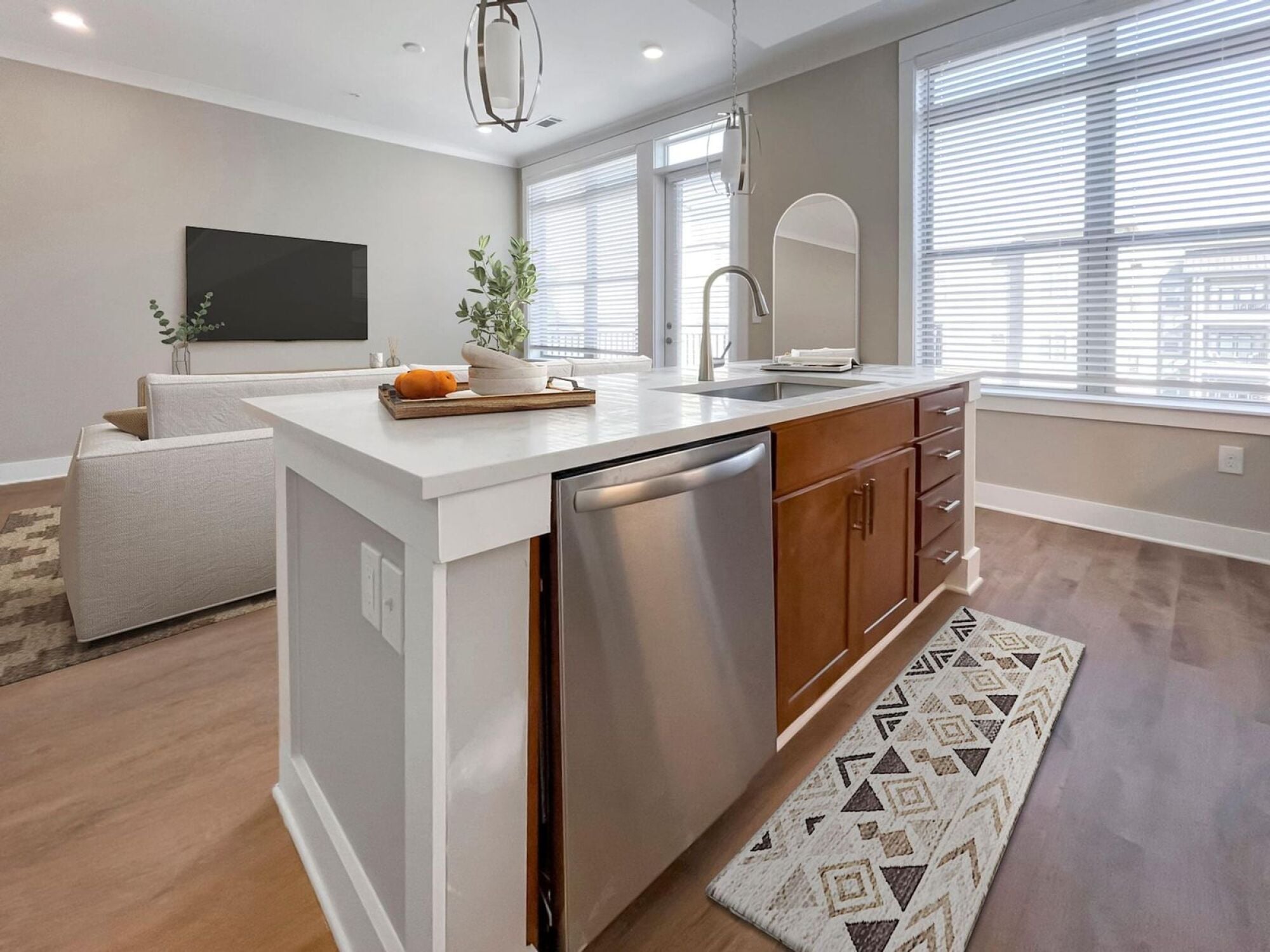Designer kitchen featuring a floating island and brown cabinets
