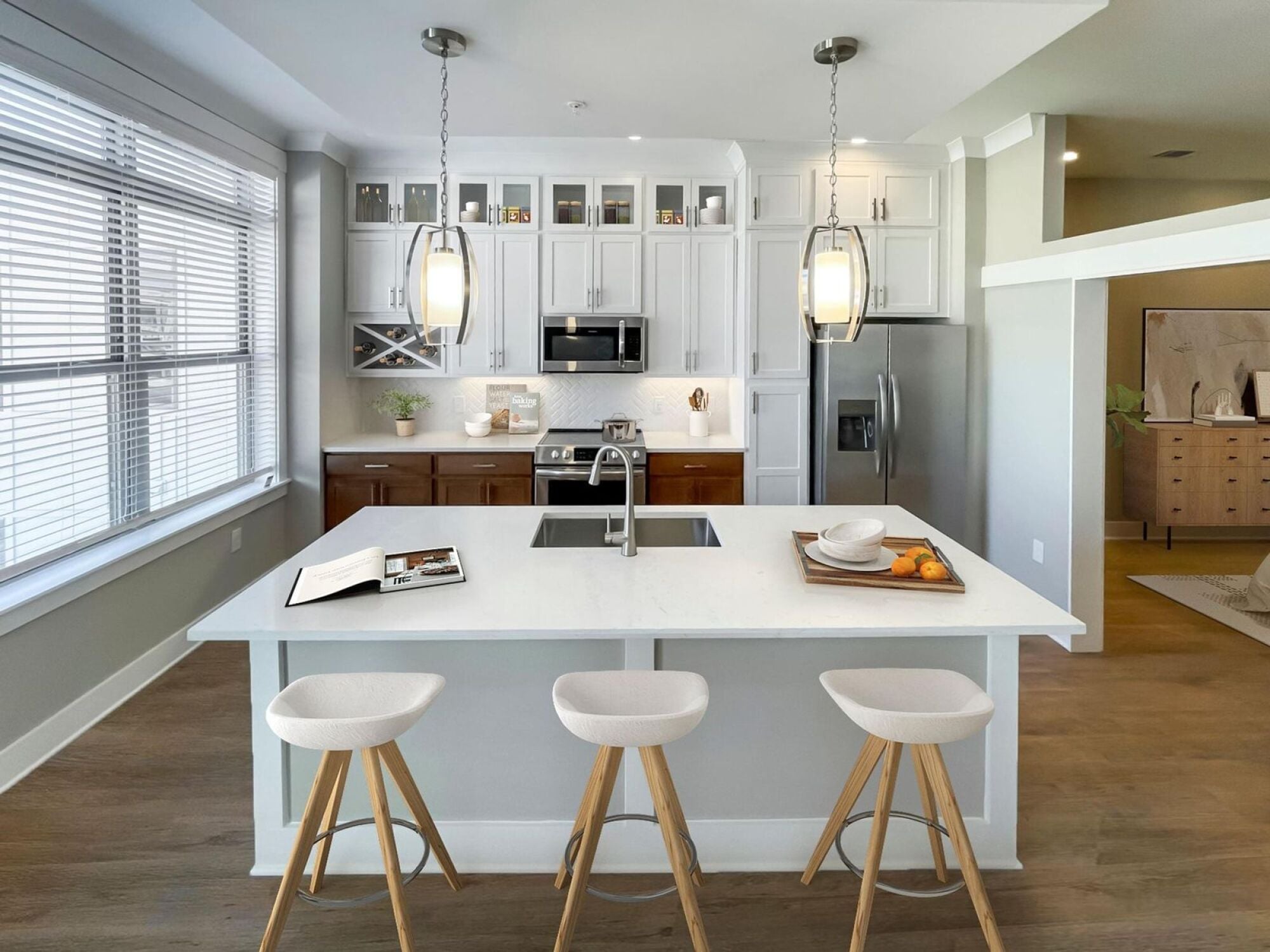 Open concept kitchen with island and bar stools