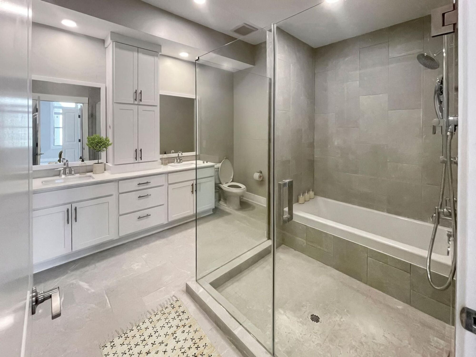 Large bathroom with glass walk in shower and tub combo