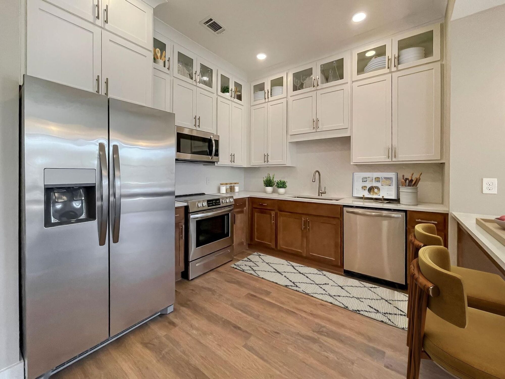 B2 designer kitchen featuring stainless steel appliances and brown white finishes