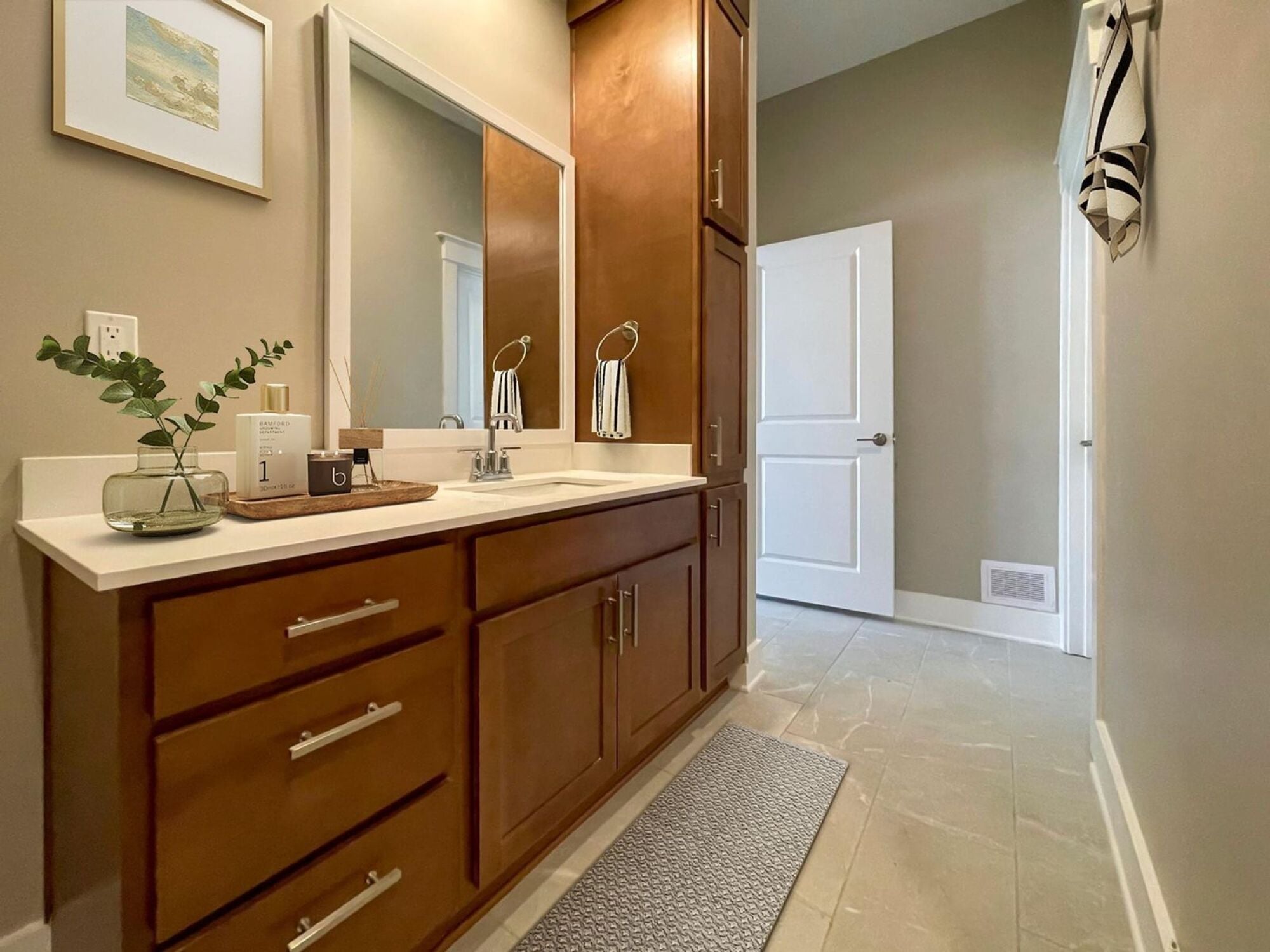 B3-P bathroom with brown cabinets and large mirror