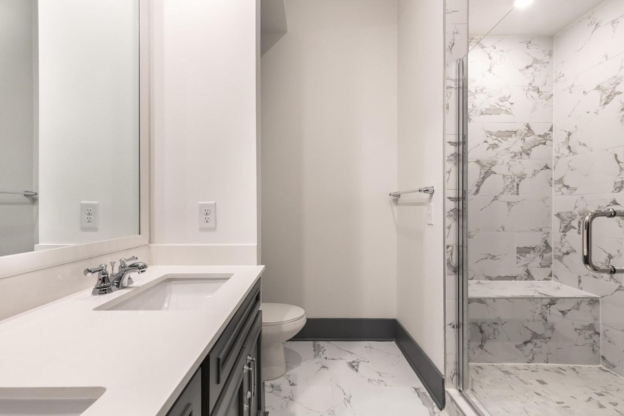 Bathroom with double vanity sinks and large walk-in shower