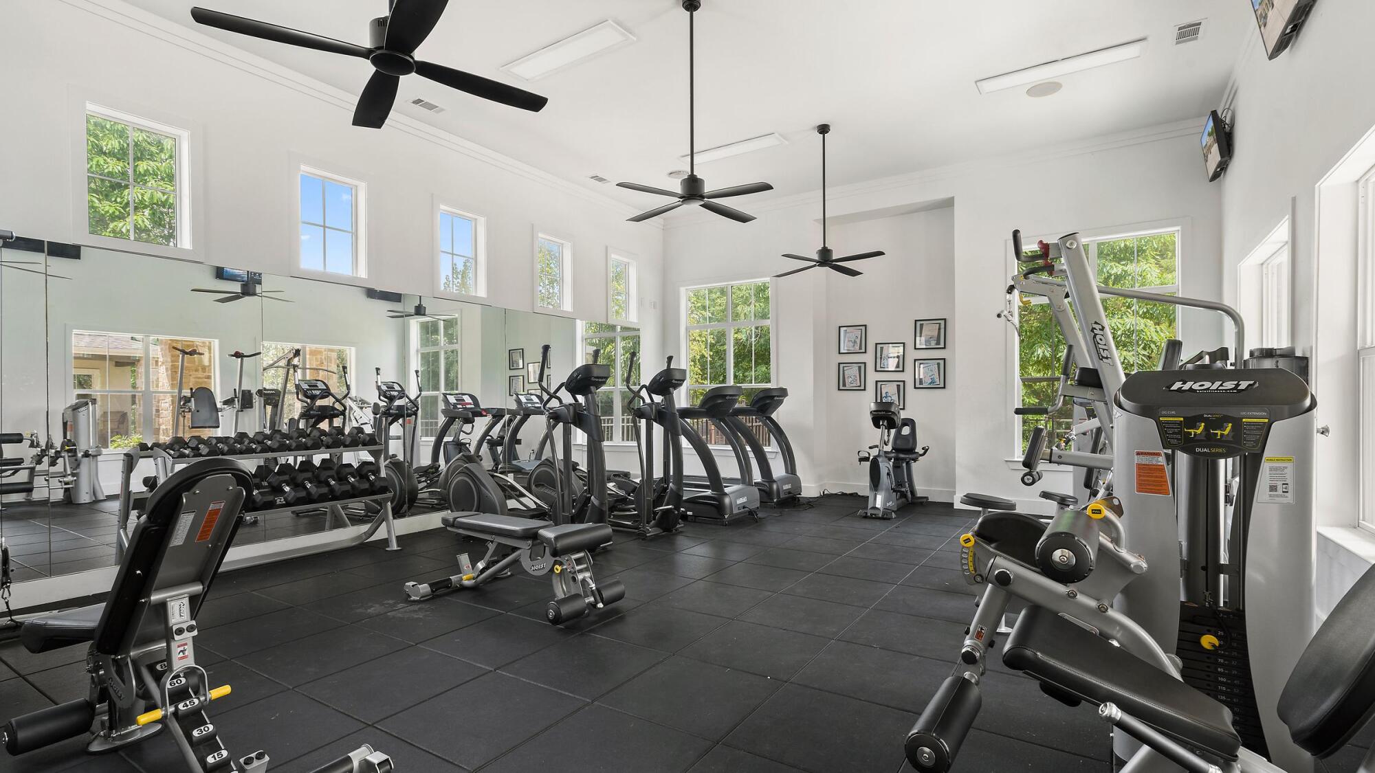Bella Ruscello fitness center in Duncanville, TX with treadmills, ellipticals, free weights, and ceiling fans in a bright open room