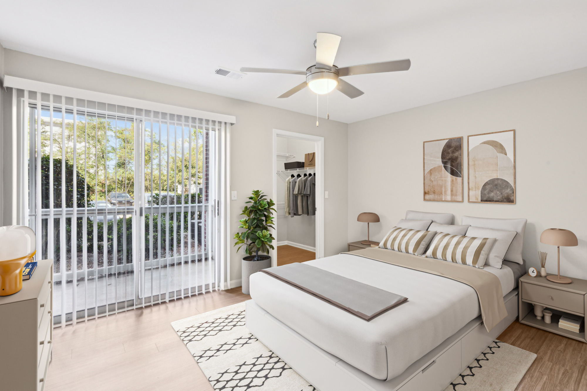 Staged bedroom at Walker's Crossing with access to a spacious walk-in closet.