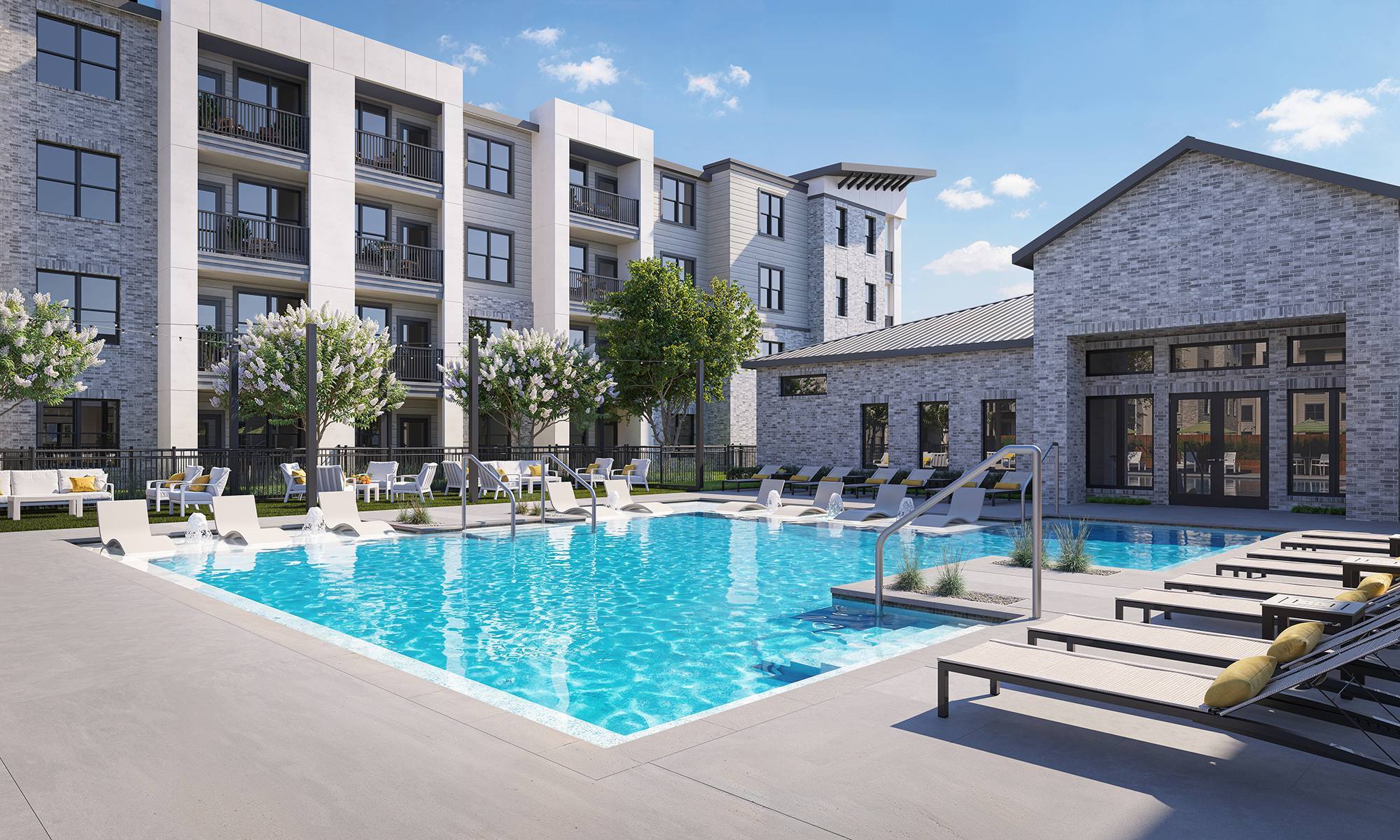 Modern apartment complex with a swimming pool, lounge chairs, and trees on a sunny day.