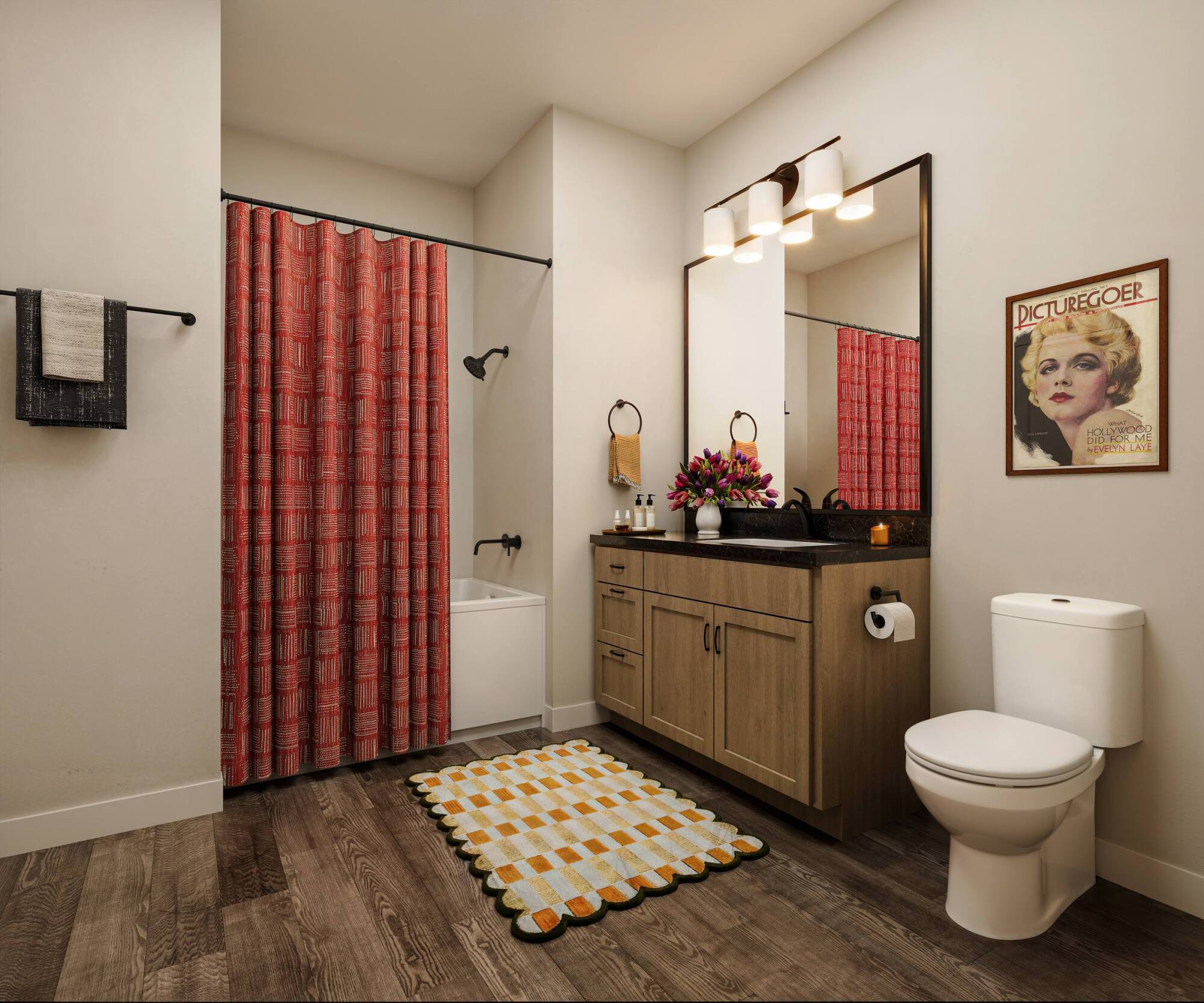 Modern bathroom with red shower curtain, wood vanity, large mirror, floral decor, and a vintage movie poster.