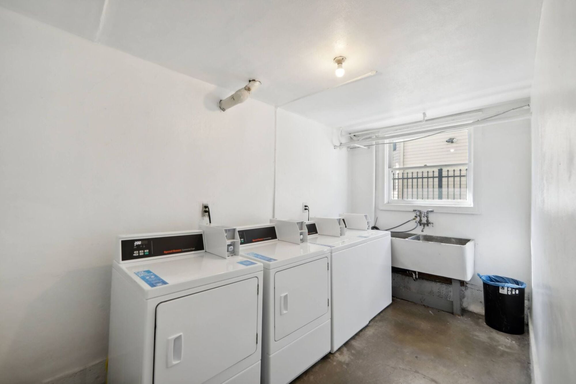 A small laundry room with a washer and dryer.