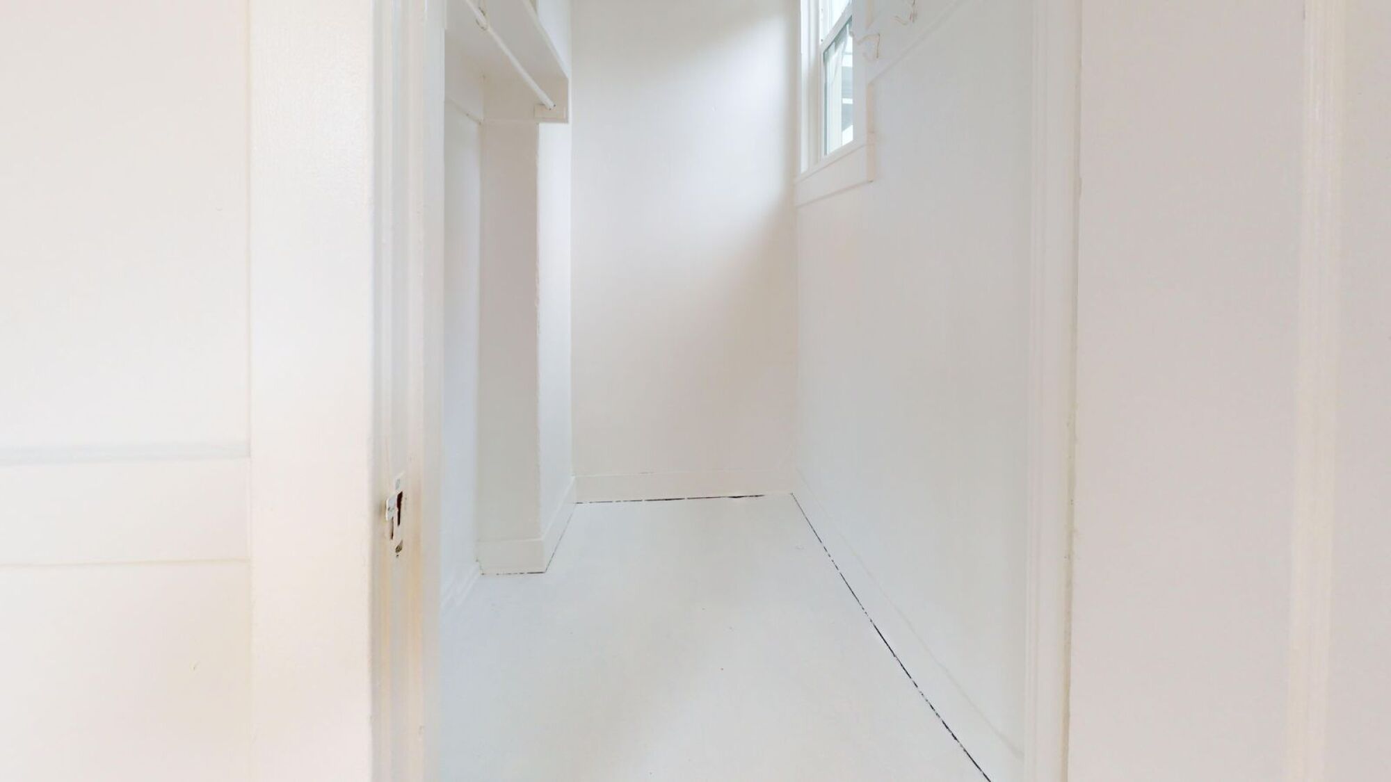 A white door is open to a hallway.