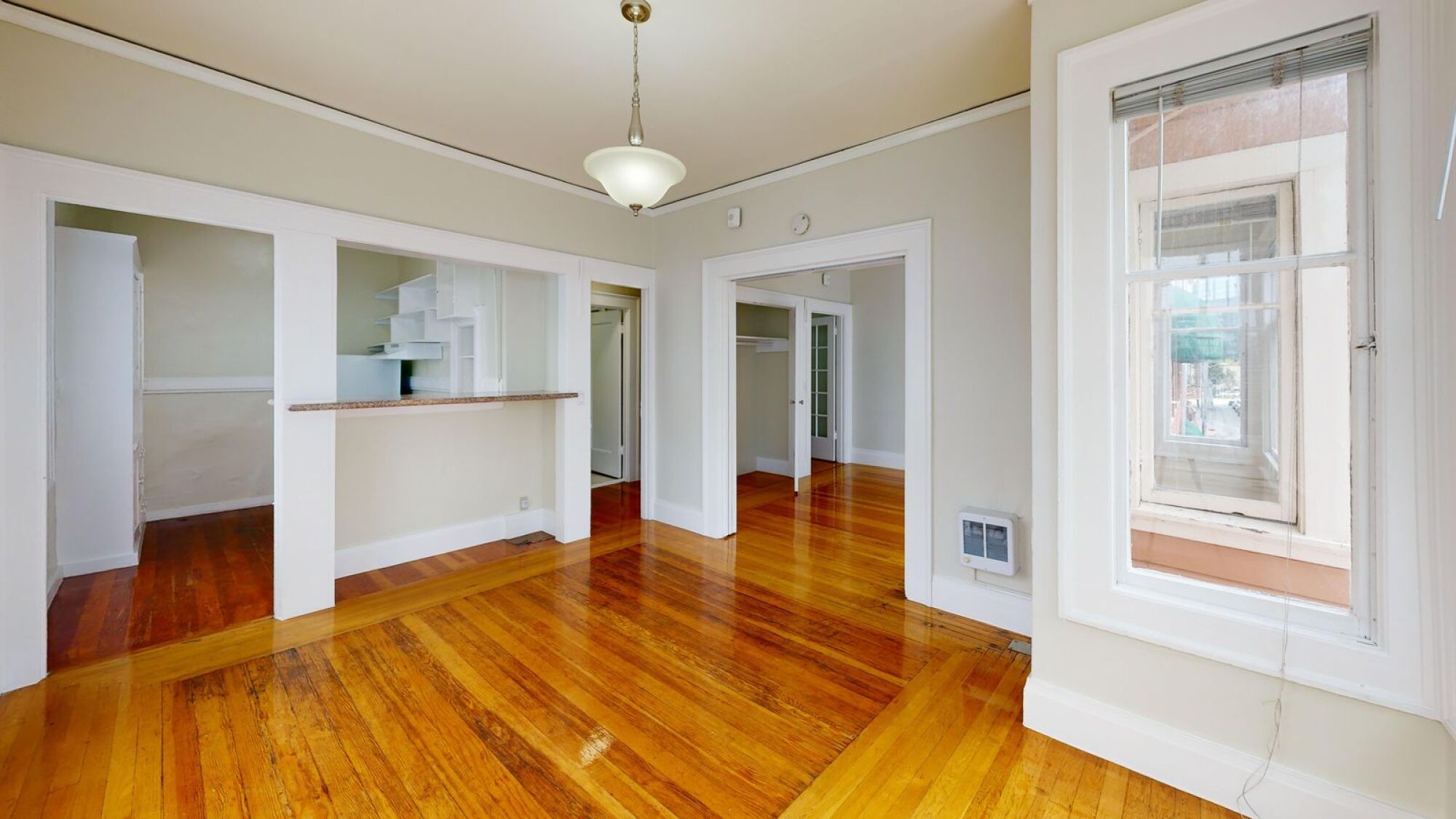 A room with wooden floors and white walls.