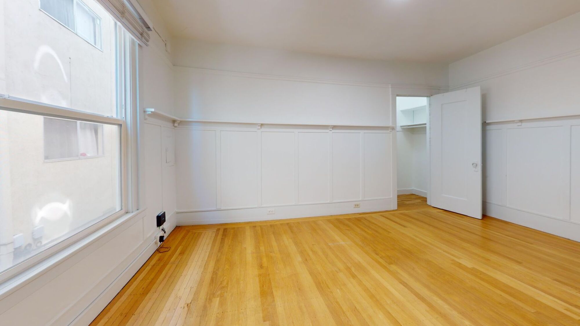 A room with wooden floors and white walls.