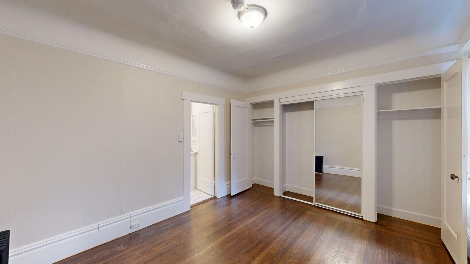 A room with white walls and wood flooring.