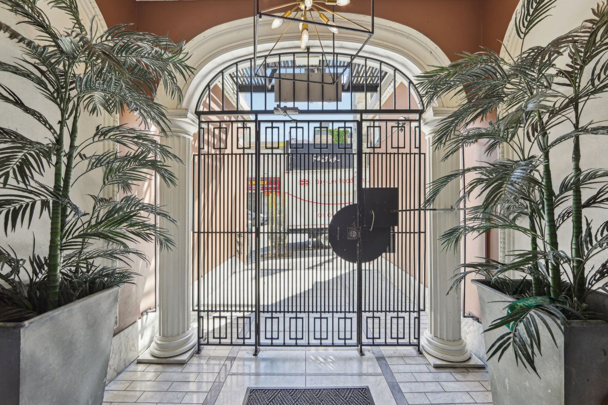 A black gate with a round sign on it.