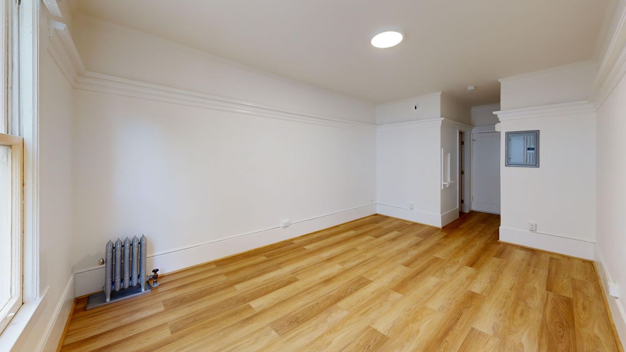 A room with wooden floors and white walls.