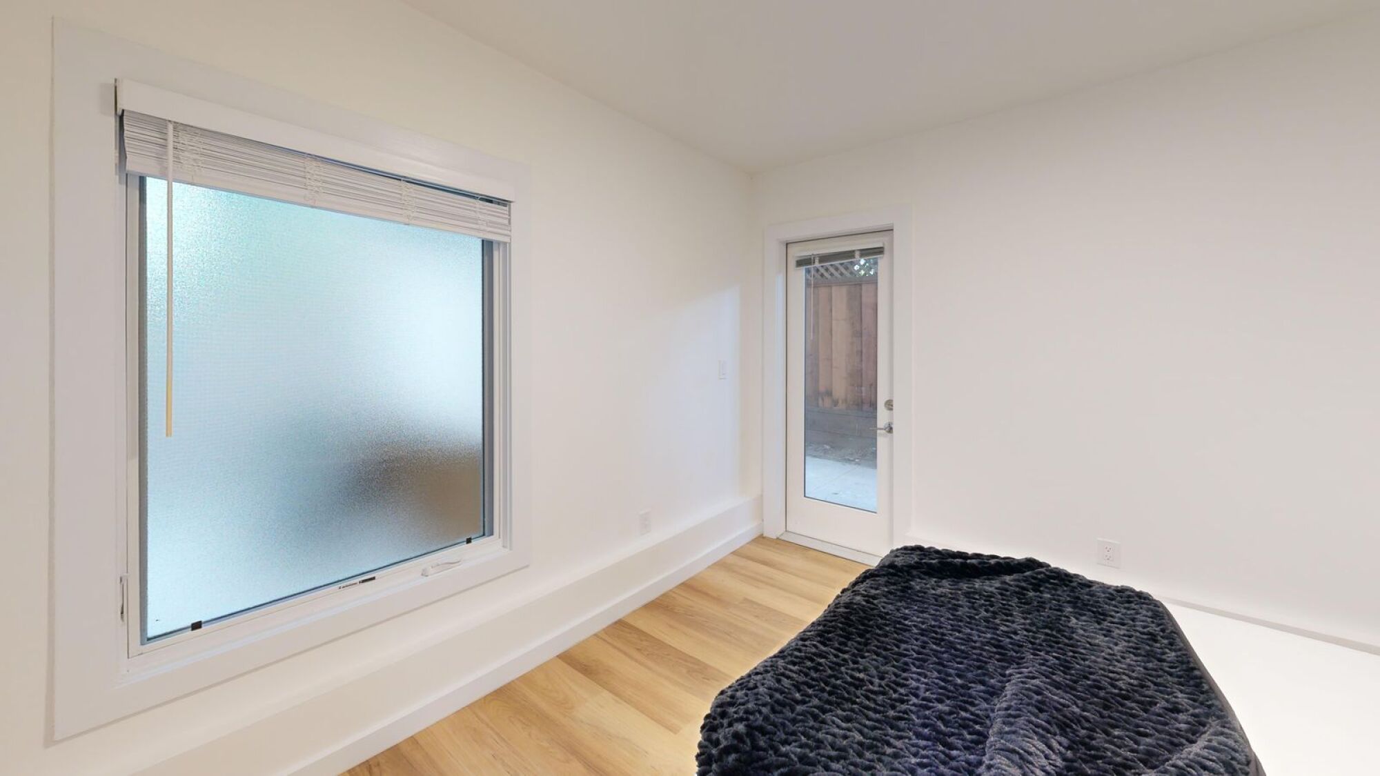 A room with a window and a door.