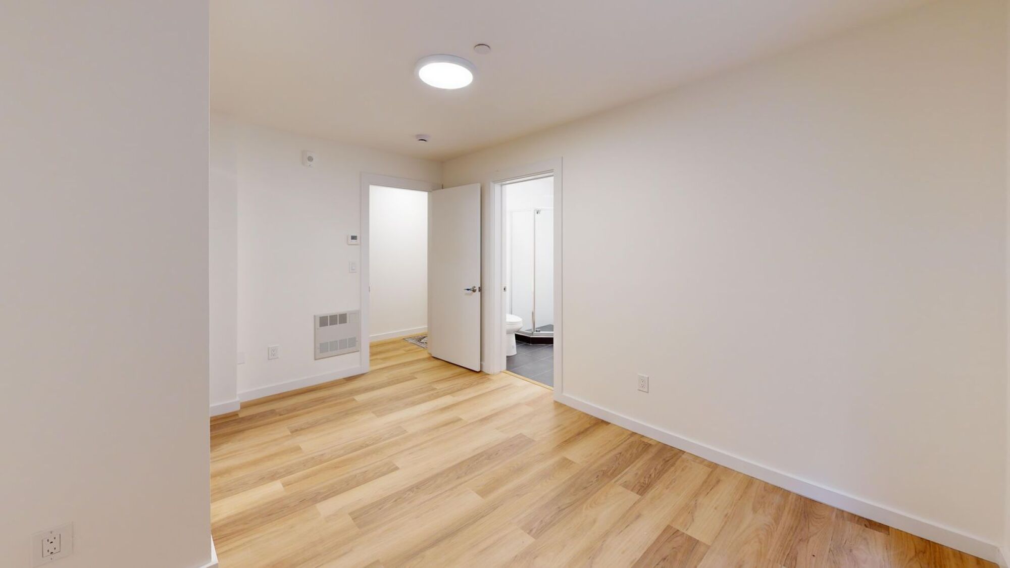 A room with wooden floors and white walls.