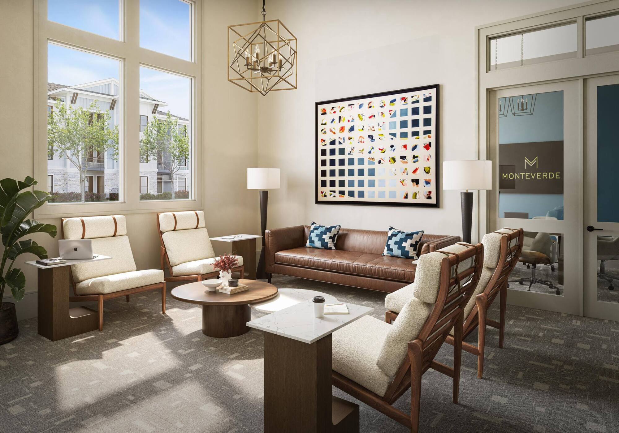 Modern lounge with large windows, brown leather sofa, cream chairs, and colorful art on the wall.