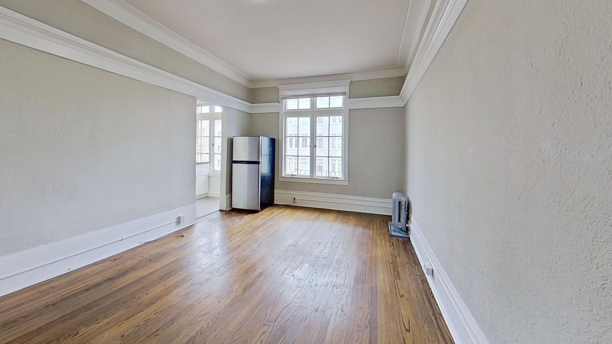 A room with wooden floors and a window.