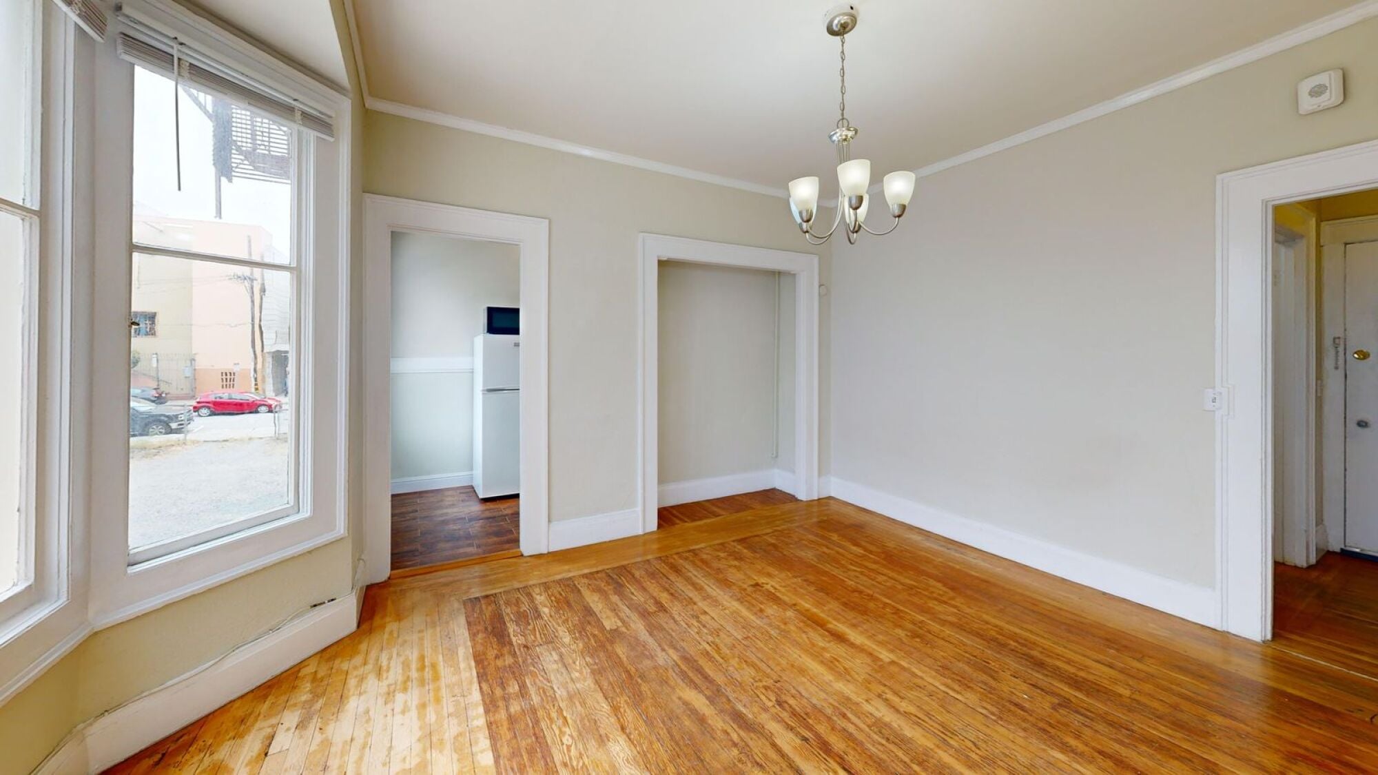 A room with wooden floors and white walls.