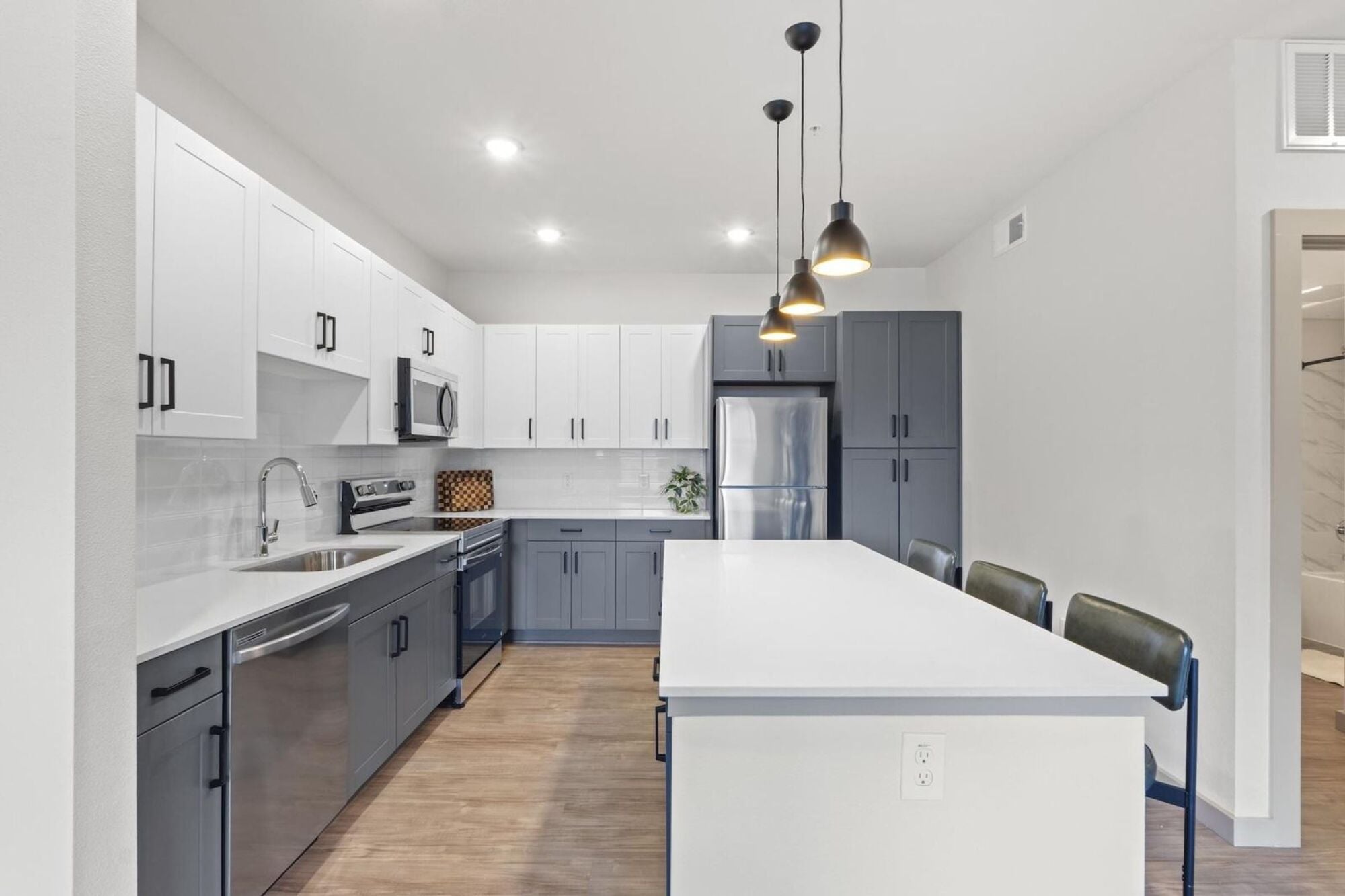 Modern Apartment Kitchen with Stainless Steel Appliances and Two-Toned Cabinetry in Austin TX