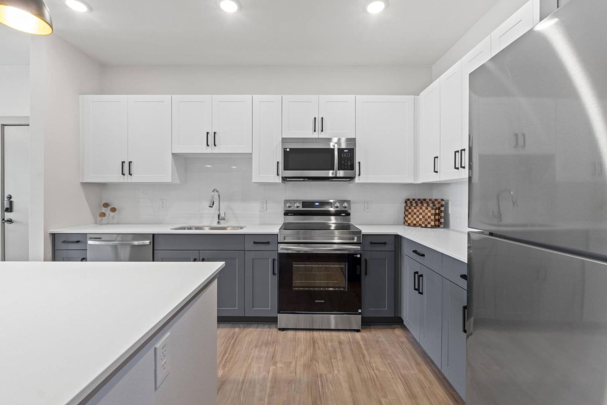 Modern Apartment kitchen with two-toned cabinetry in Austin TX