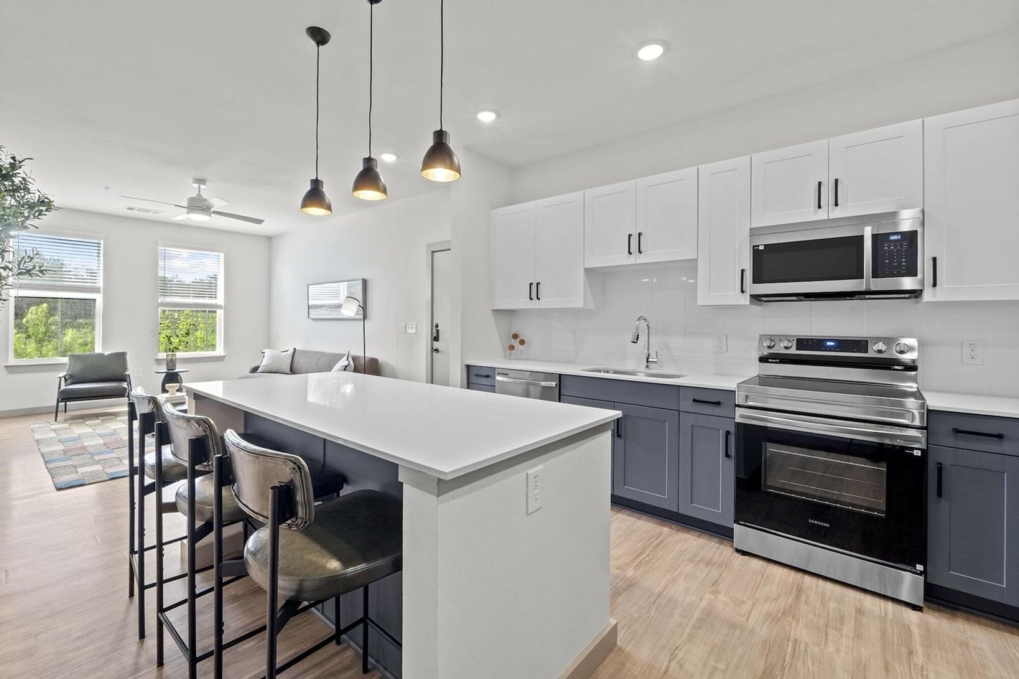 Modern Apartment Kitchen with stainless steel appliances, two-toned cabinetry, and quartz countertops in Austin TX