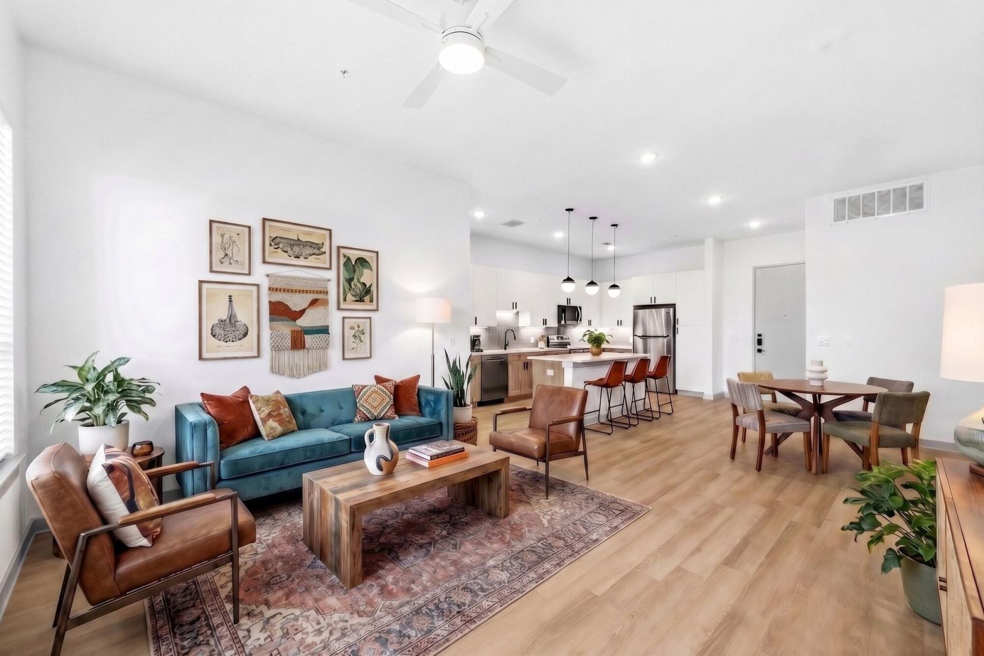 A virtually staged kitchen, living, and dining room at Wixby House in Austin, Texas.