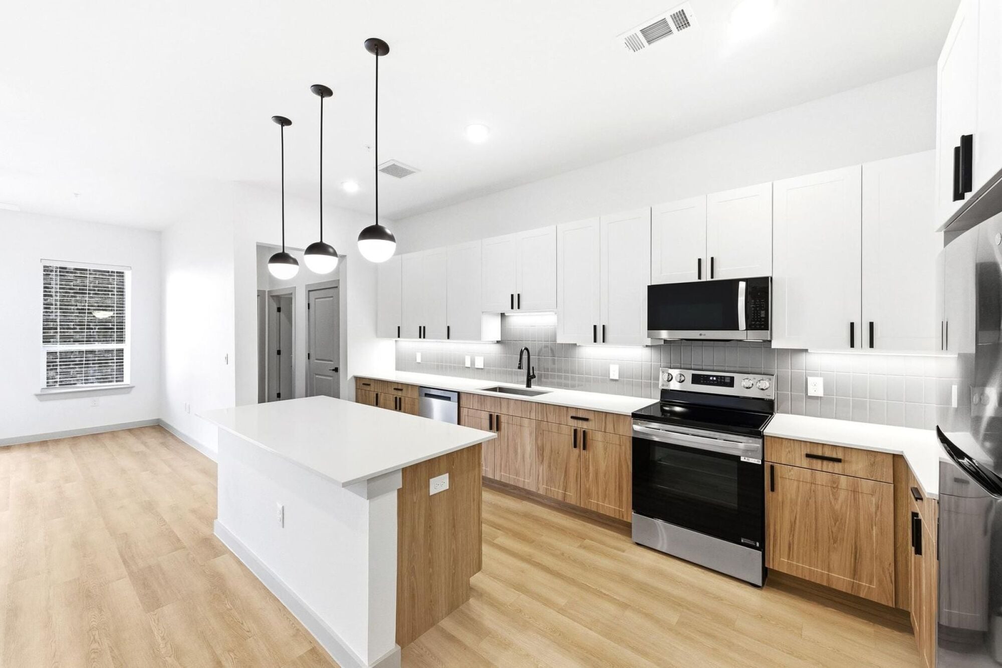 Designer inspired kitchens with stainless steel appliances at Wixby House in Austin, Texas.