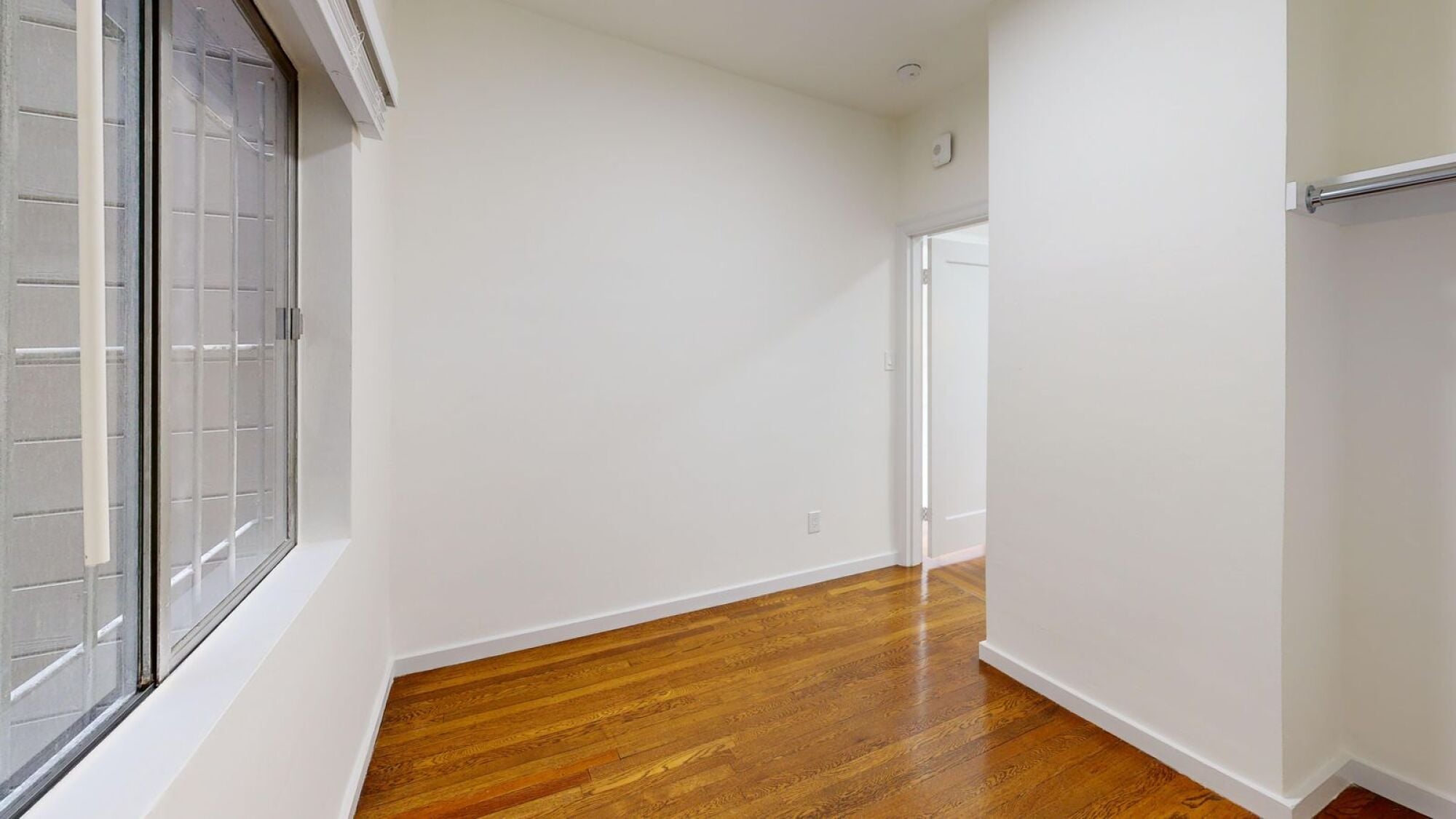 A room with wooden floors and white walls.