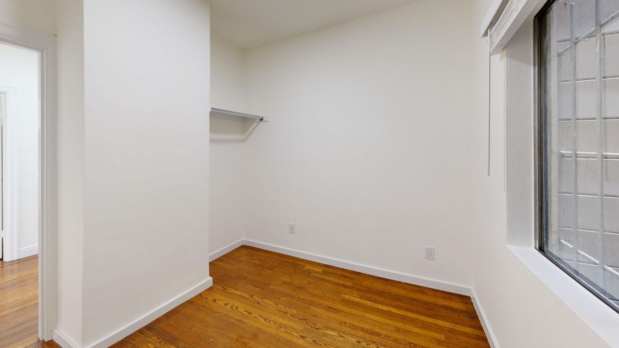 A room with wooden floors and white walls.
