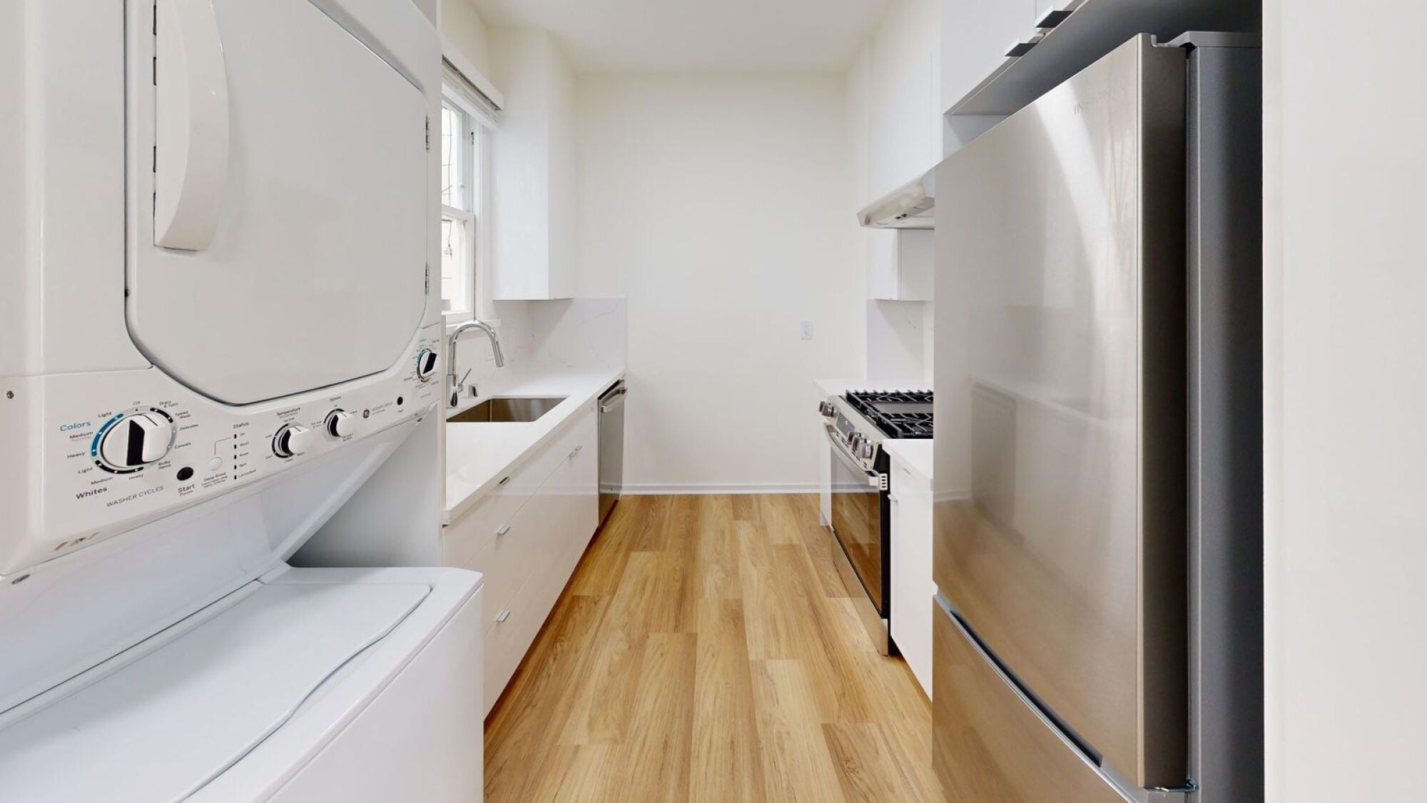 A modern kitchen with a white oven and a stainless steel refrigerator.