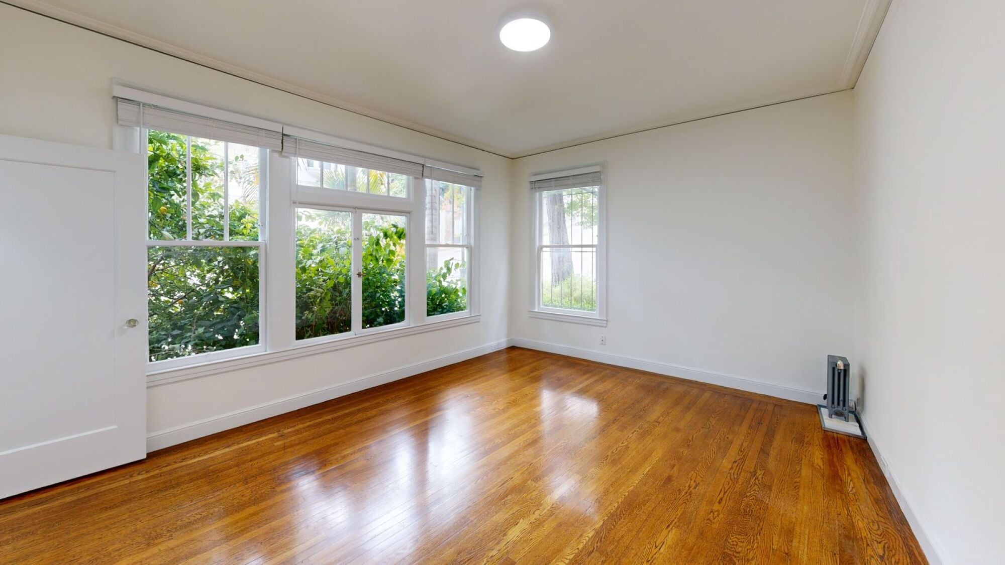 A room with wooden floors and white walls.
