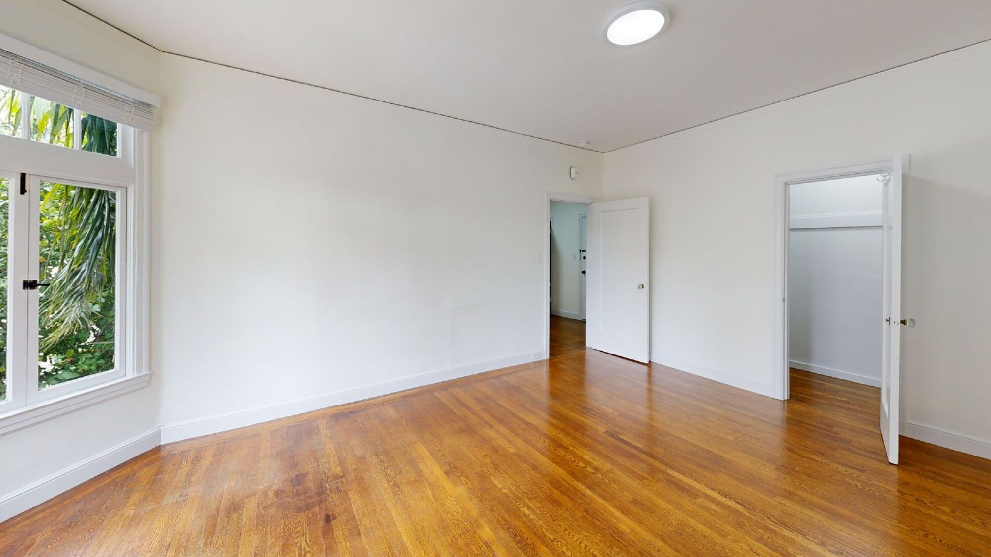 A room with wooden floors and white walls.