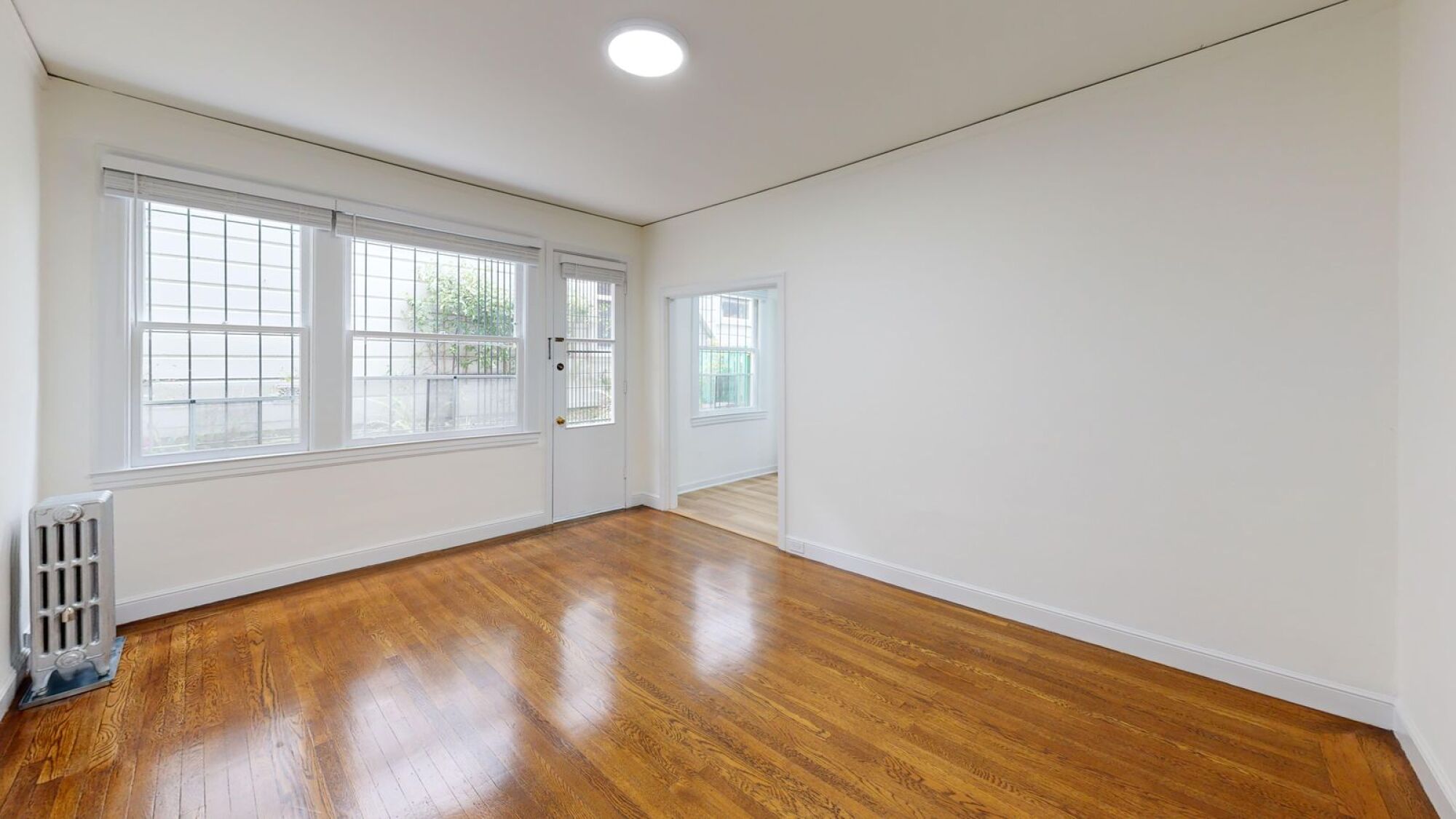 A room with wooden floors and white walls.