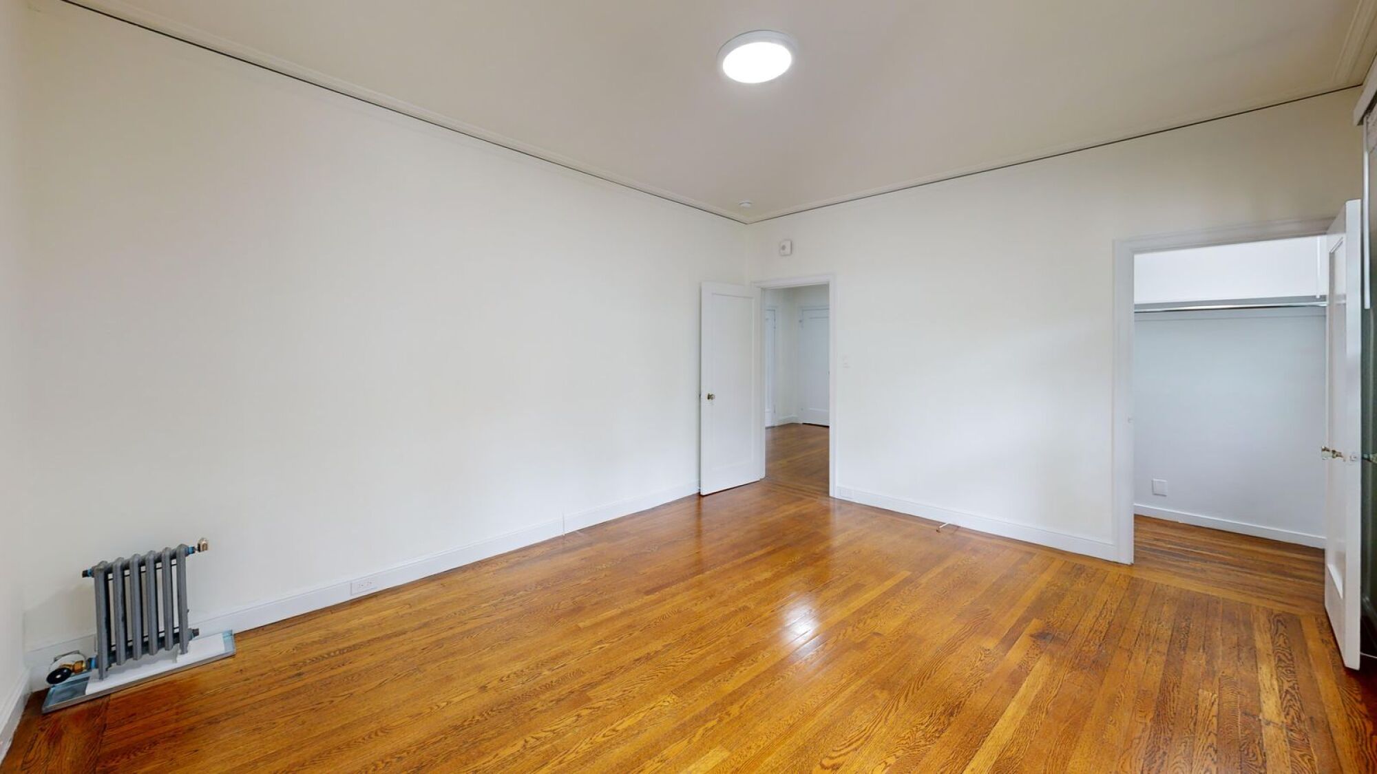 A room with wooden floors and white walls.