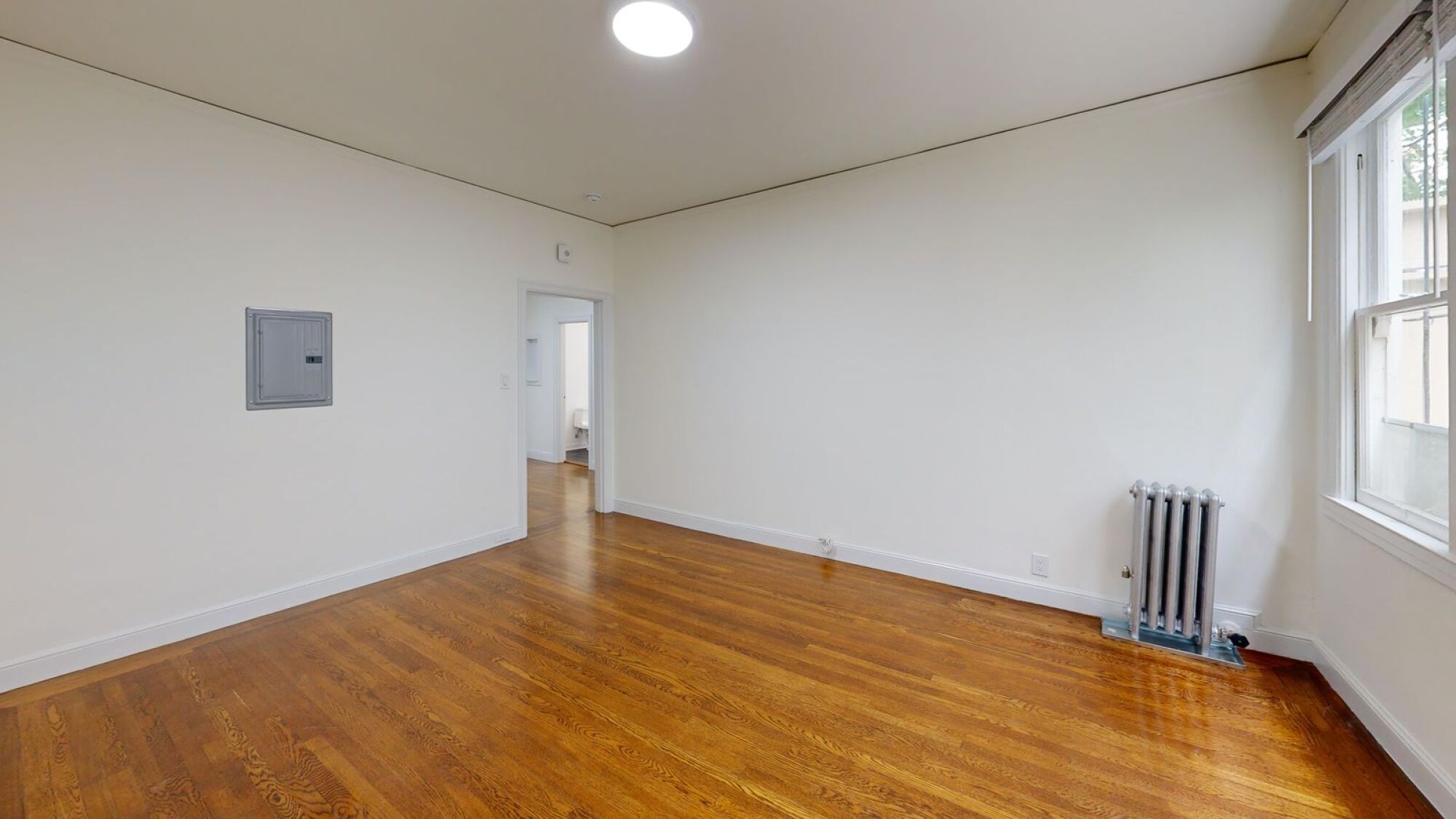 A room with wooden floors and white walls.