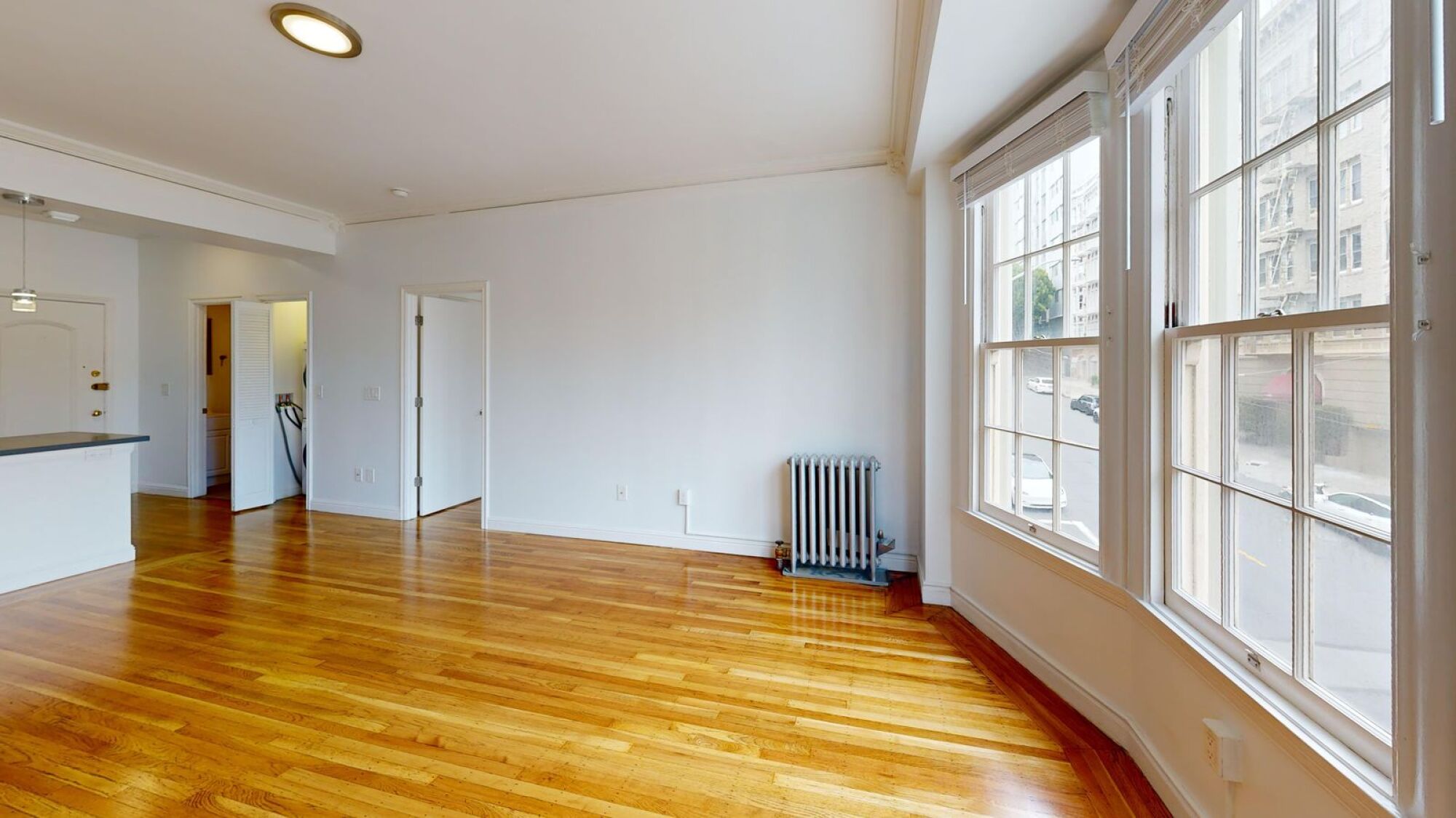 A room with wooden floors and white walls.