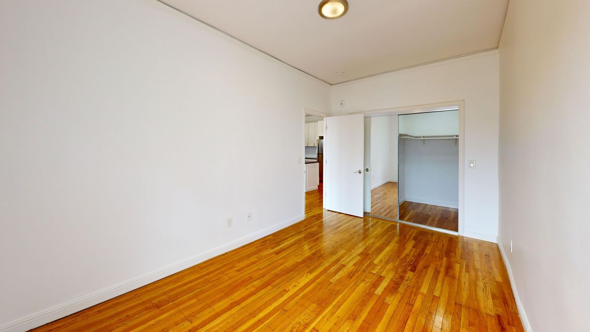 A room with wooden floors and white walls.