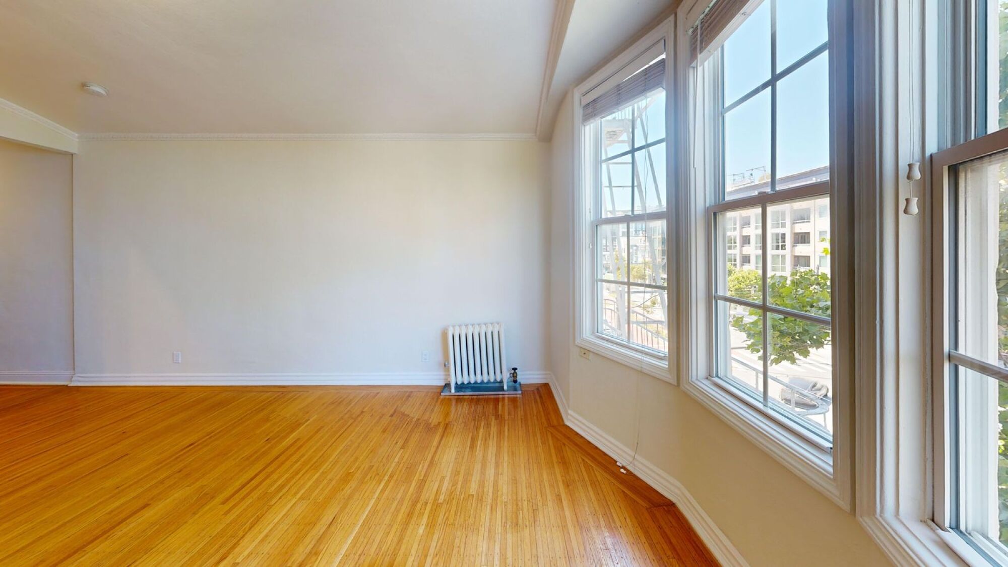 A room with a radiator and a window.