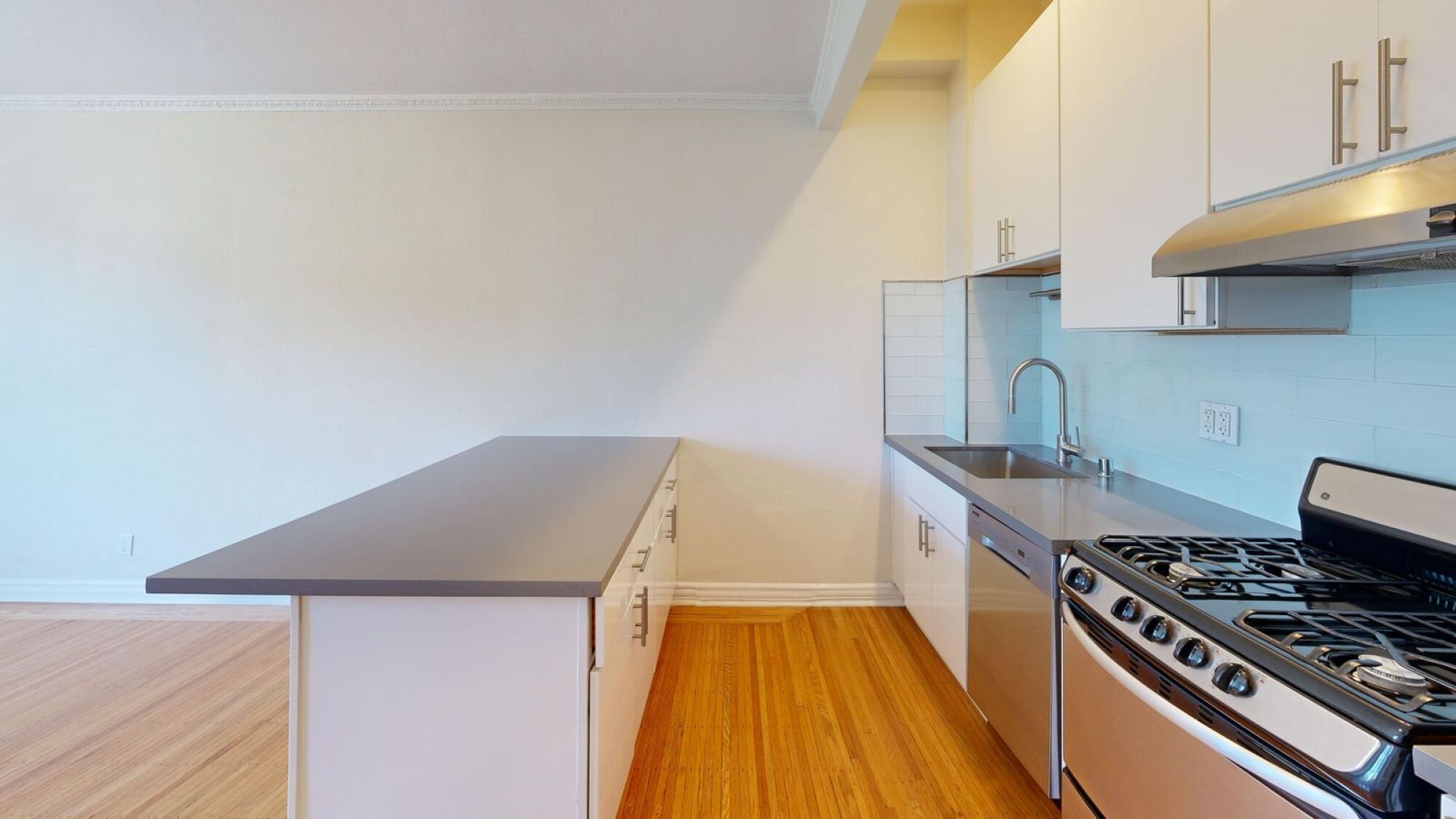 A kitchen with a stove and cabinets.