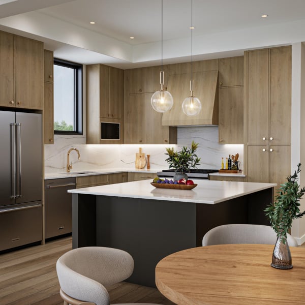 Modern kitchen with wooden cabinets, island, hanging lights, and a round dining table with chairs.